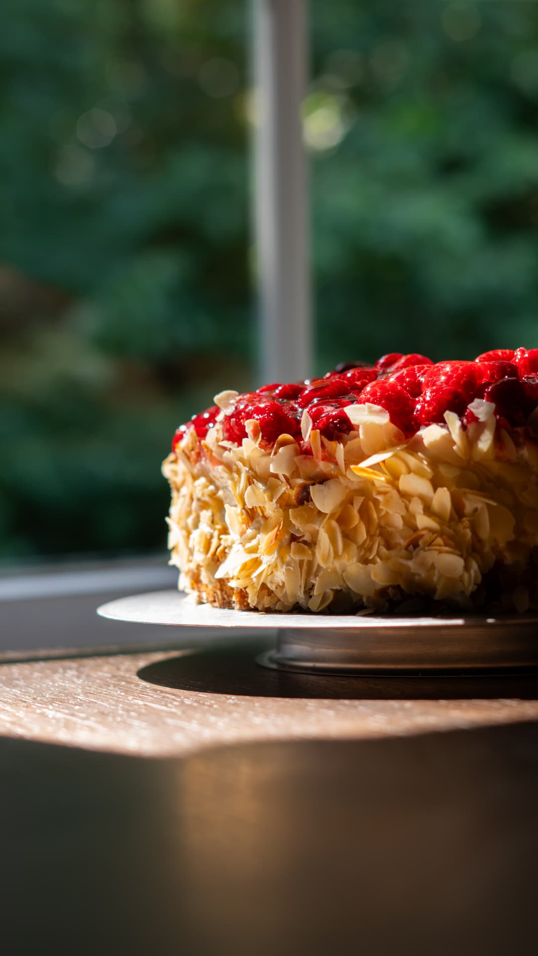 Beerentorte mit Mandelblättchen am Fenster